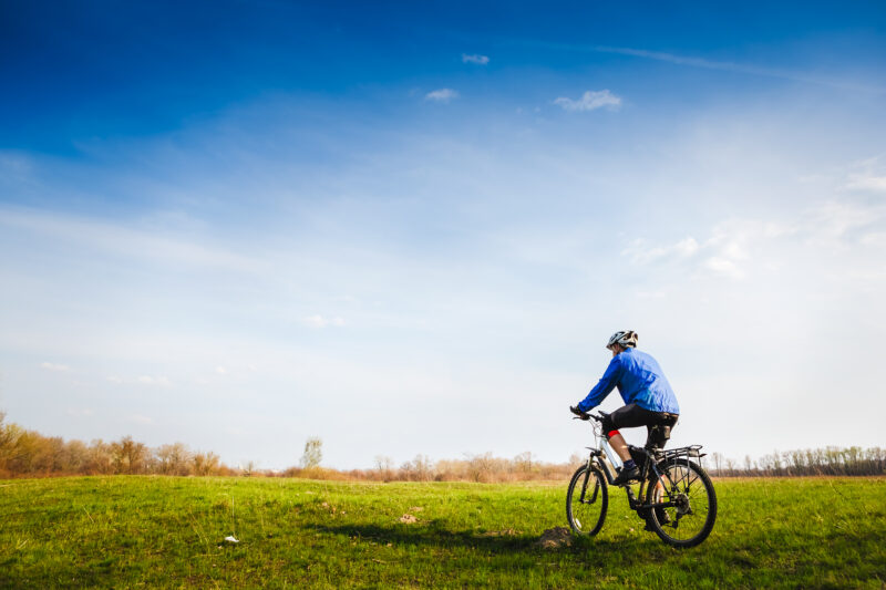 Young,Cyclist,On,The,Beautiful,Meadow,Trail,On,Sunny,Day